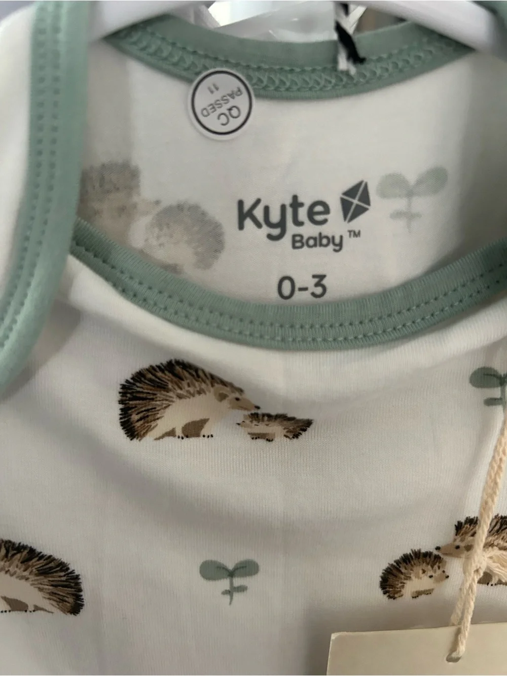 Kyte BABY White Onesie with Sage Trim and Hedgehog Print